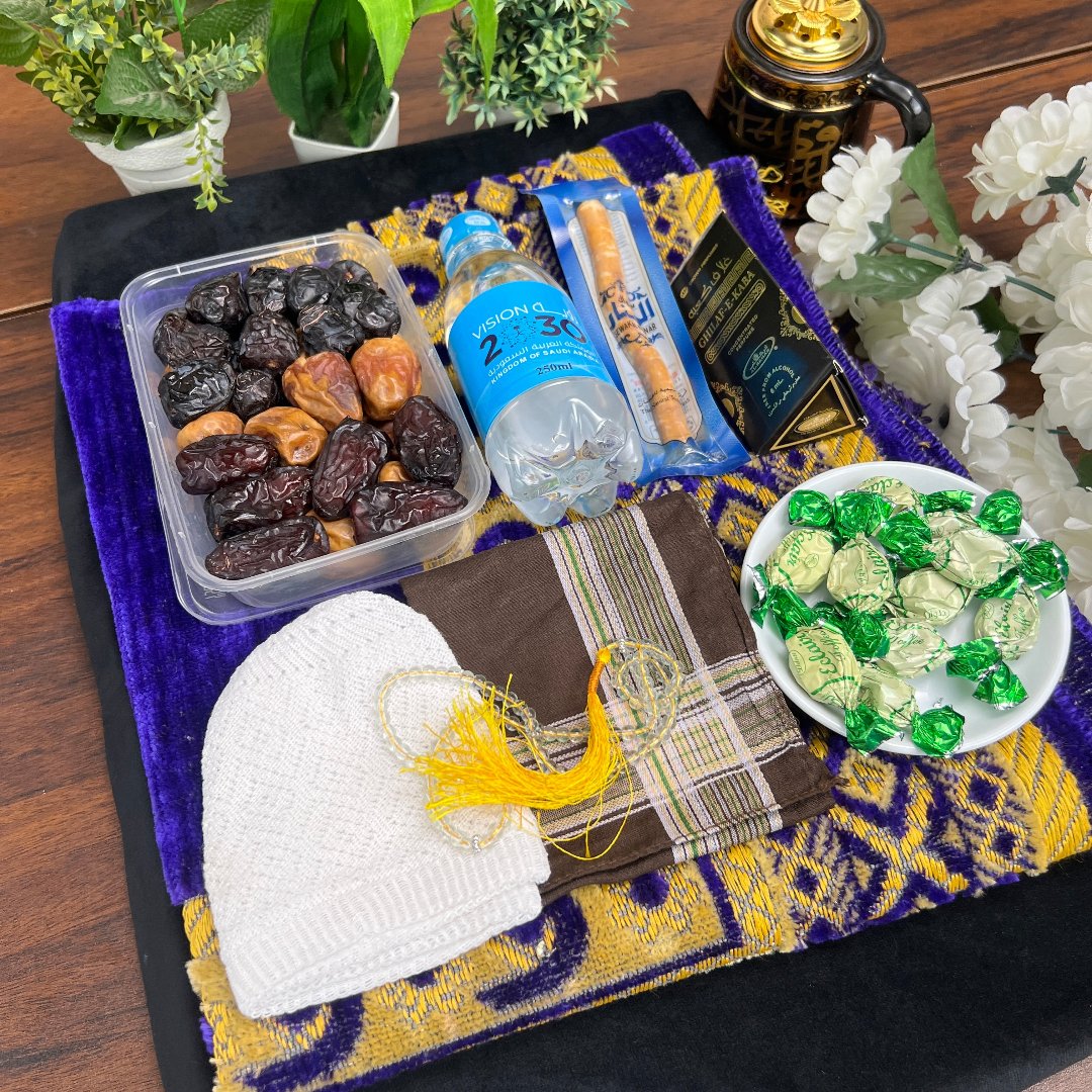 Complete Hibah e Hajj gift package with Zamzam and prayer items.
