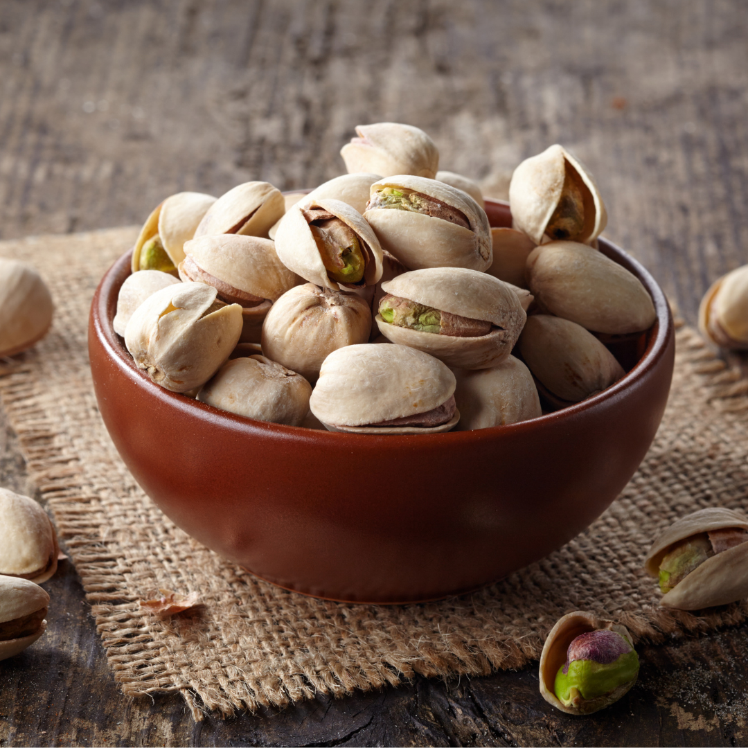 A bowl of crunchy pistachios in their shells, perfect for healthy snacking.