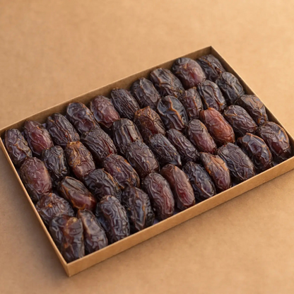 Premium Medjool Dates arranged in a box , highlighting their large size and chewy texture