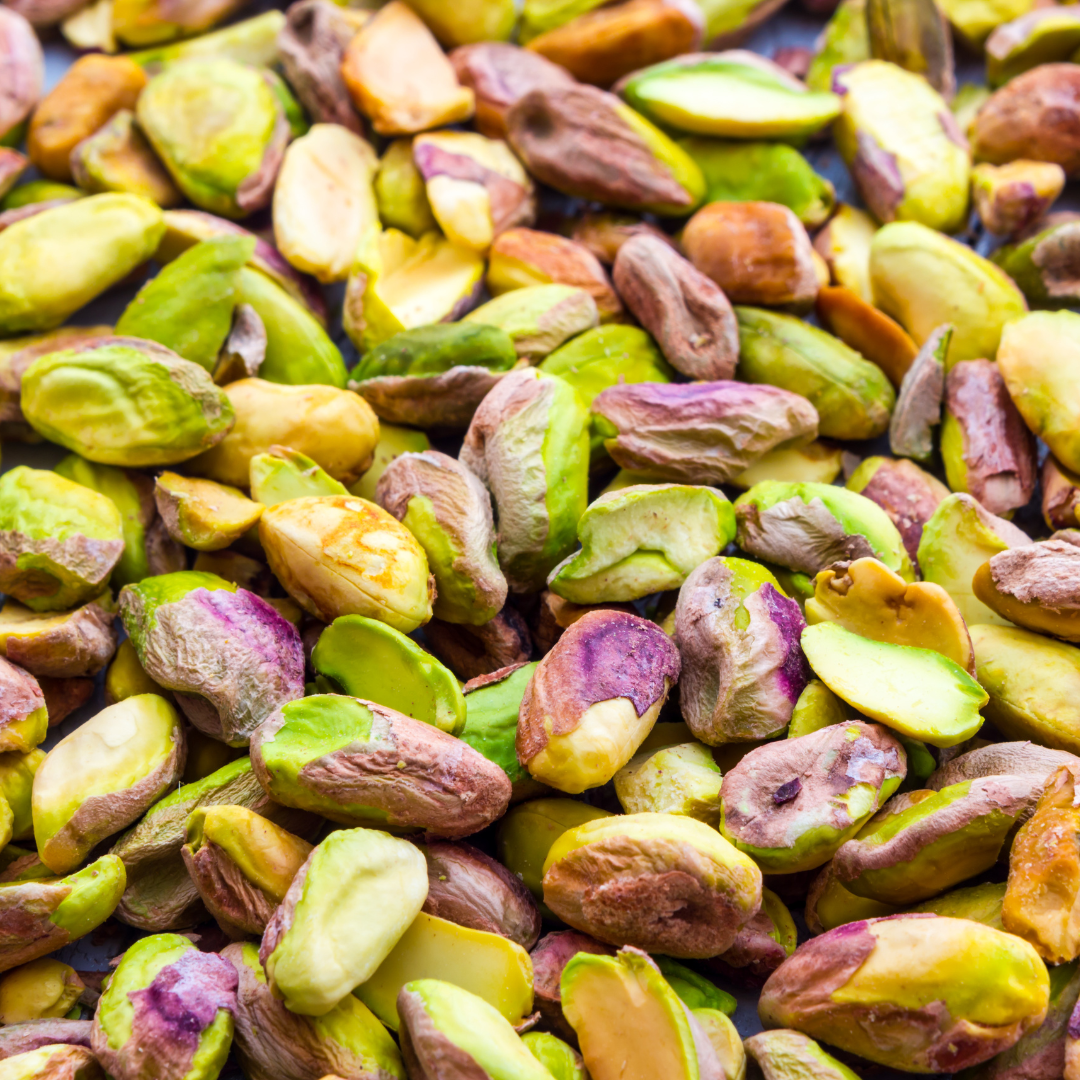 Close-up of fresh and shelled pistachios in a bowl, perfect for healthy eating.
