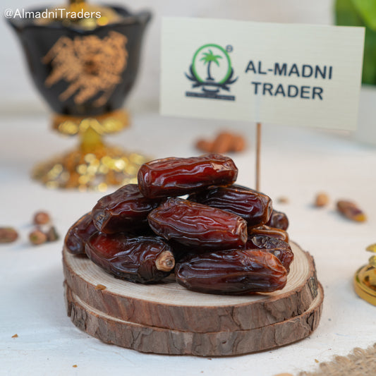 Saudi Mabroom dates on a wooden board by Al Madni Traders